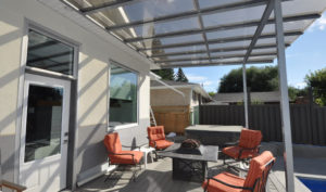 Glass patio cover in backyard of home
