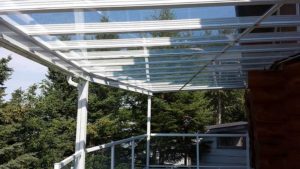 Side view of all glass patio cover on raised deck
