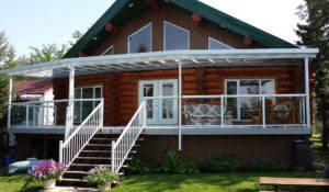 Large all glass patio cover and glass railings on log house