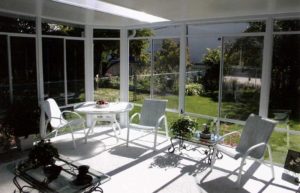 Interior view of glass walled sunroom with skylight