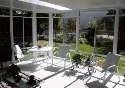 Interior view of glass walled sunroom with skylight