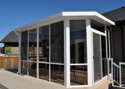 Aluminum sunroom with glass walls and screens