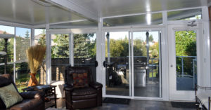 Interior of sunroom on deck with bbq and tile floor