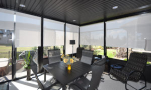 Interior view of a 3 season sunroom with dark panels and aluminum