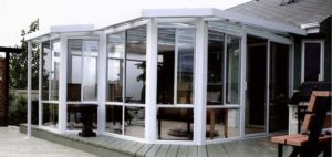 Custom shape sunroom with glass walls and roof