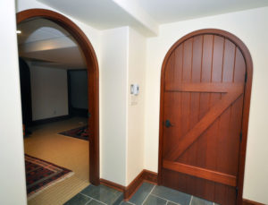 Dark stained wooden door made of wood slats