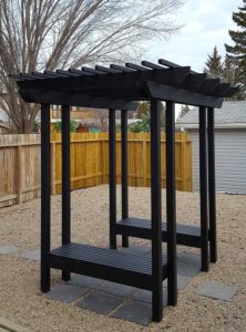 Aluminum pergola in backyard with built in benches