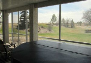 Screen room with hot tub and prairie view